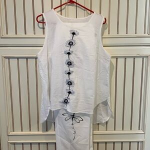 Cream colored, pantsuit size extra large with black trimthis was paired together